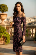 Woman wearing a baroque inspired midi cocktail dress with off-shoulder design holding a glass of champagne