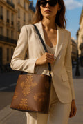 Brown baroque print bucket handbag from Angelic Blessings Shop worn by woman in beige suit with sunglasses