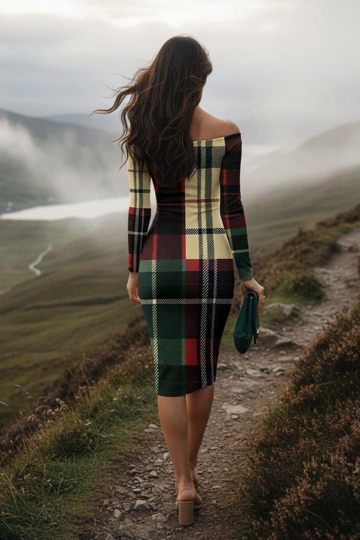 Woman wearing a burgundy tartan off shoulder midi dress walking on a mountain path