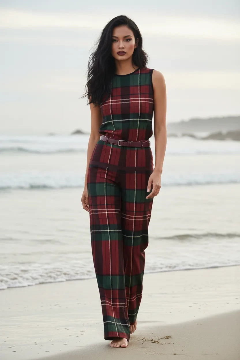 Woman wearing burgundy green tartan trousers women with matching sleeveless top on the beach