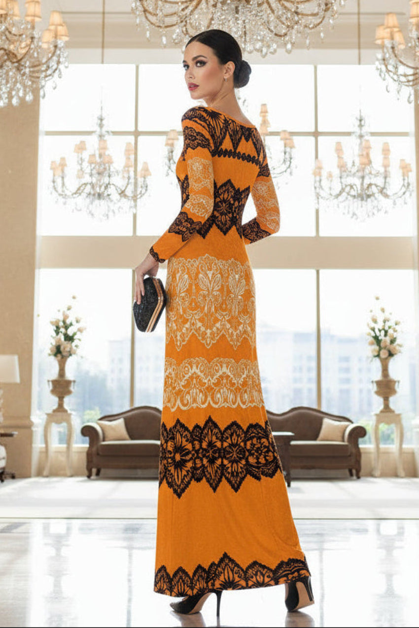 Luxury gold velvet evening gown with black lace details worn by a model in an elegant chandelier-lit hall