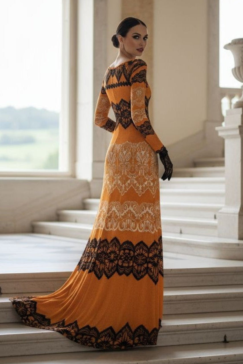 Luxury gold velvet evening gown with black lace detailing worn by model on staircase