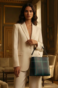 Woman in beige suit holding old money style crossbody purse with green plaid pattern