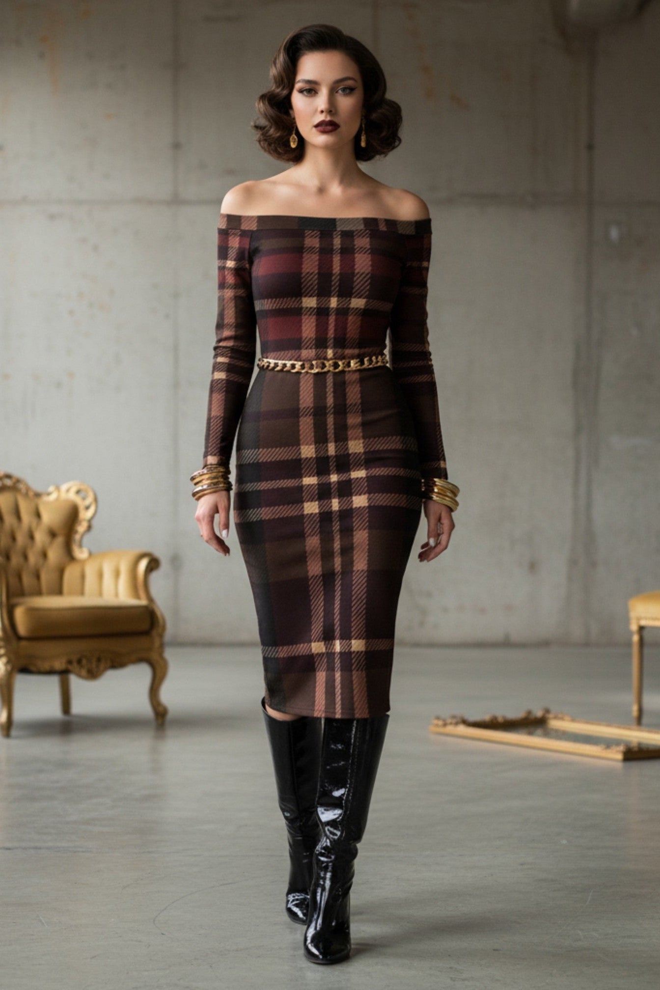 Woman wearing a tartan off the shoulder midi dress with long sleeves and a gold chain belt